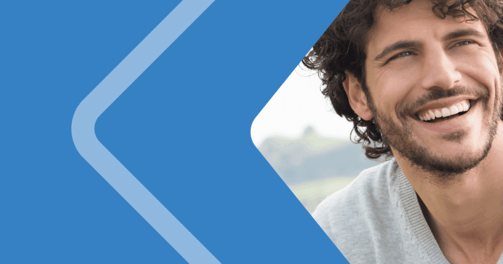 What-sars-move-to-digital-means-to-tax-compliance Smiling professional on a blue background representing SARS's transition to 100% digital tax compliance in South Africa.